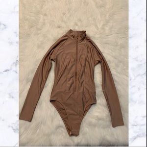 Tan zip up body suit with snaps